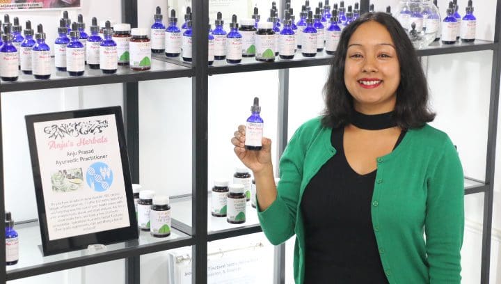 Woman Holding A Small Bottle
